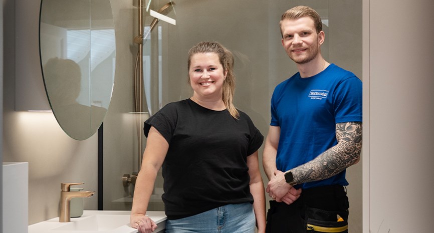 Kunde og rørlegger på det nye badet i duse farger