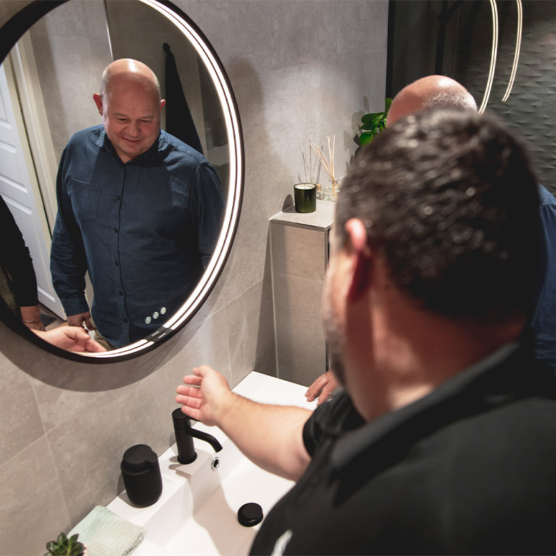 Prosjektleder Thomas Samuelsen viser hvordan lysjusteringen på speilet fungerer